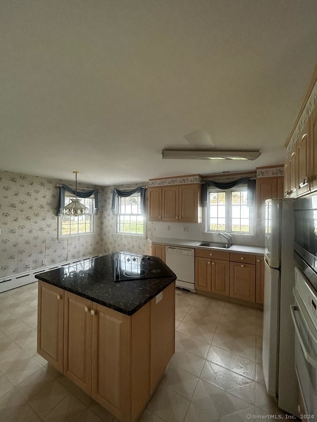 kitchen with stainless steel appliances, a kitchen island, a wealth of natural light, and sink