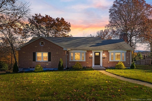 ranch-style home with a lawn