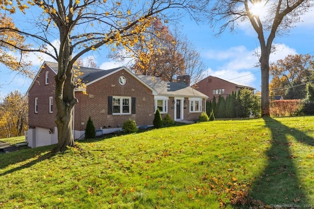 single story home with a front yard and a garage