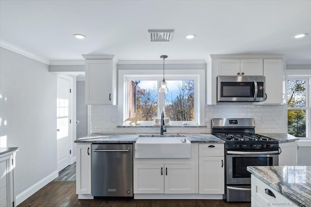 kitchen featuring white cabinets, light stone countertops, sink, and appliances with stainless steel finishes