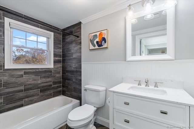 full bathroom with vanity, toilet, tiled shower / bath, and crown molding