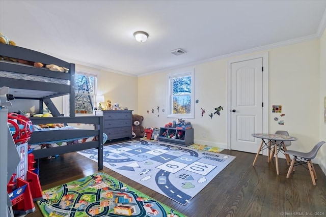 bedroom with ornamental molding and dark wood-type flooring