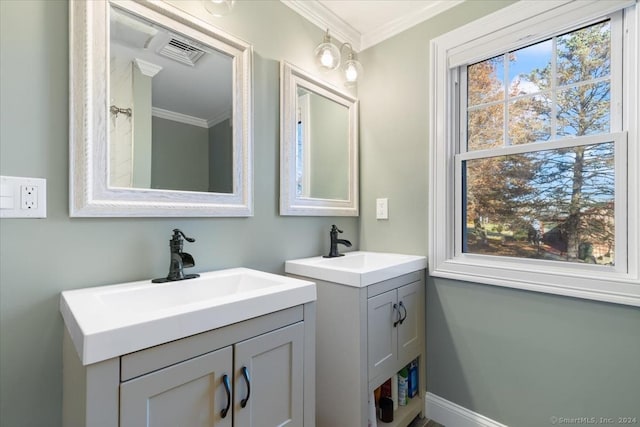 bathroom featuring plenty of natural light, crown molding, and vanity