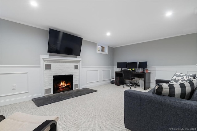 living room featuring carpet flooring, ornamental molding, and a fireplace