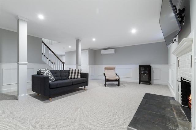 living room featuring ornamental molding, carpet floors, a fireplace, and a wall mounted AC