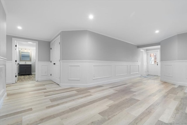 interior space featuring light hardwood / wood-style floors and ornamental molding