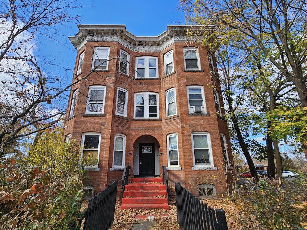 499 Zion St, Hartford, CT 06106 - multi unit property with brick siding, a fenced front yard, and cooling unit