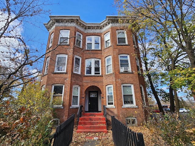499 Zion St, Hartford, CT 06106 - multi unit property with brick siding, a fenced front yard, and cooling unit