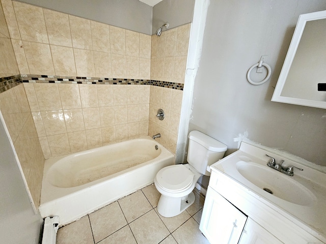 full bathroom with a baseboard radiator, toilet, tile patterned floors, tiled shower / bath, and vanity