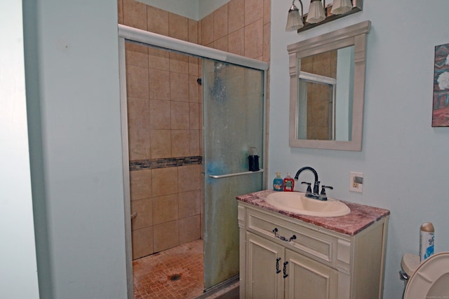 bathroom with vanity and a shower with door