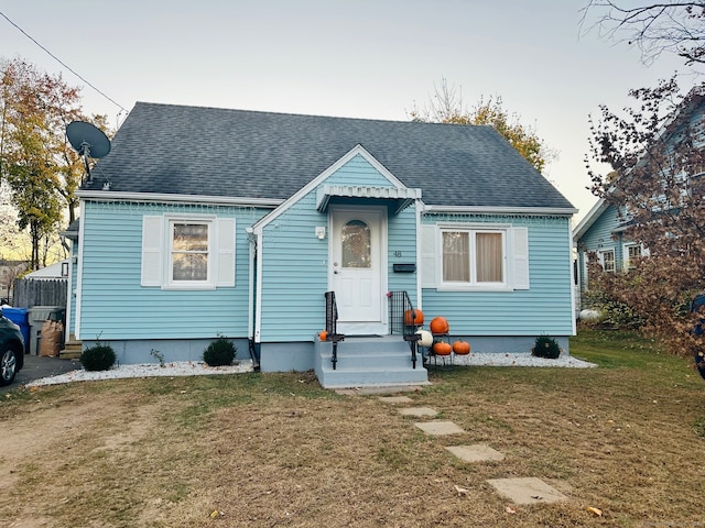 bungalow-style home featuring a front yard