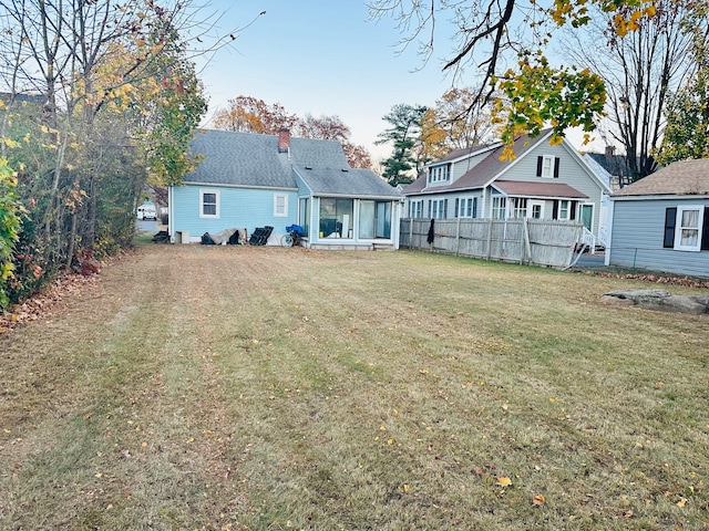 back of house featuring a lawn