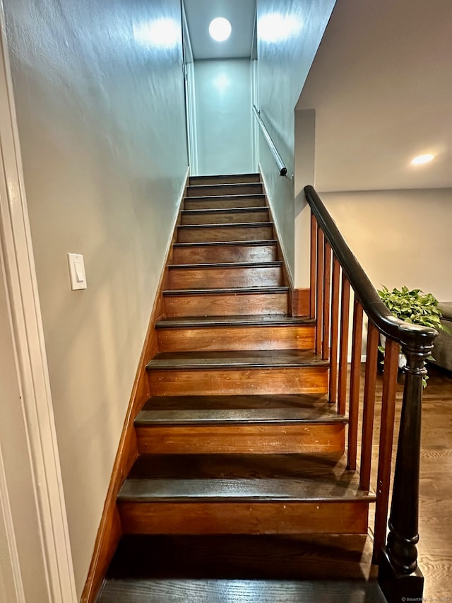 staircase featuring hardwood / wood-style flooring