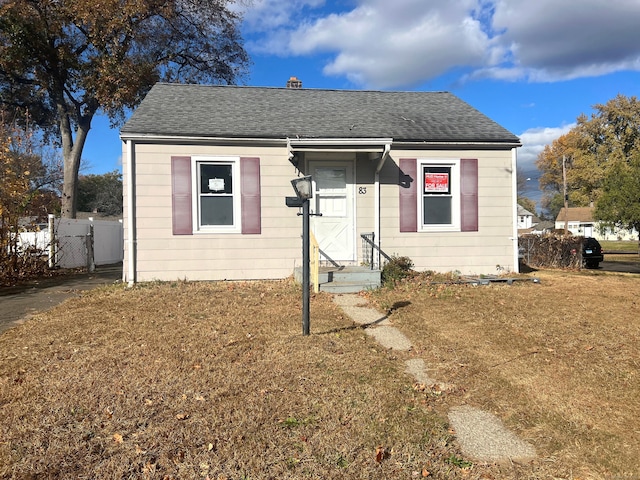 bungalow-style home featuring a front yard