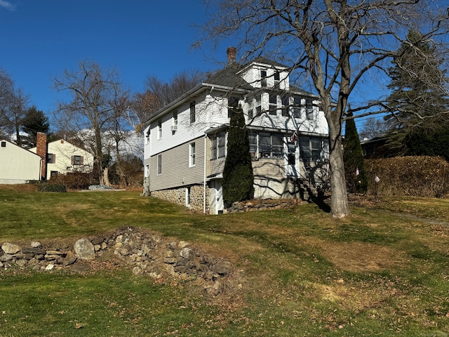 view of side of property with a lawn