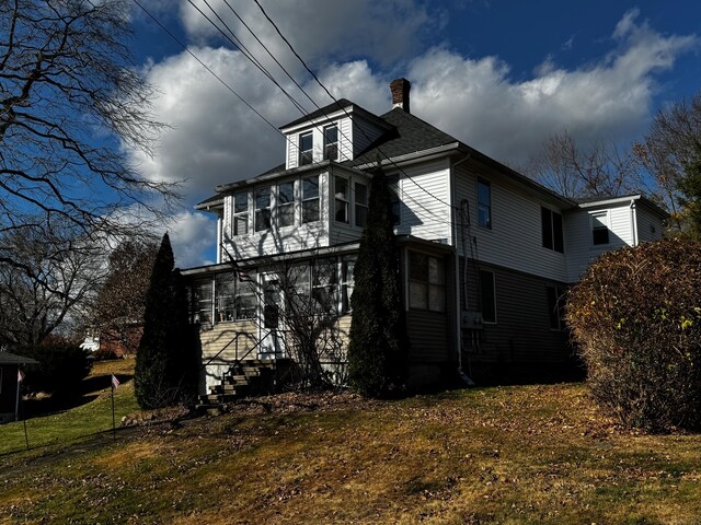 view of side of property with a sunroom