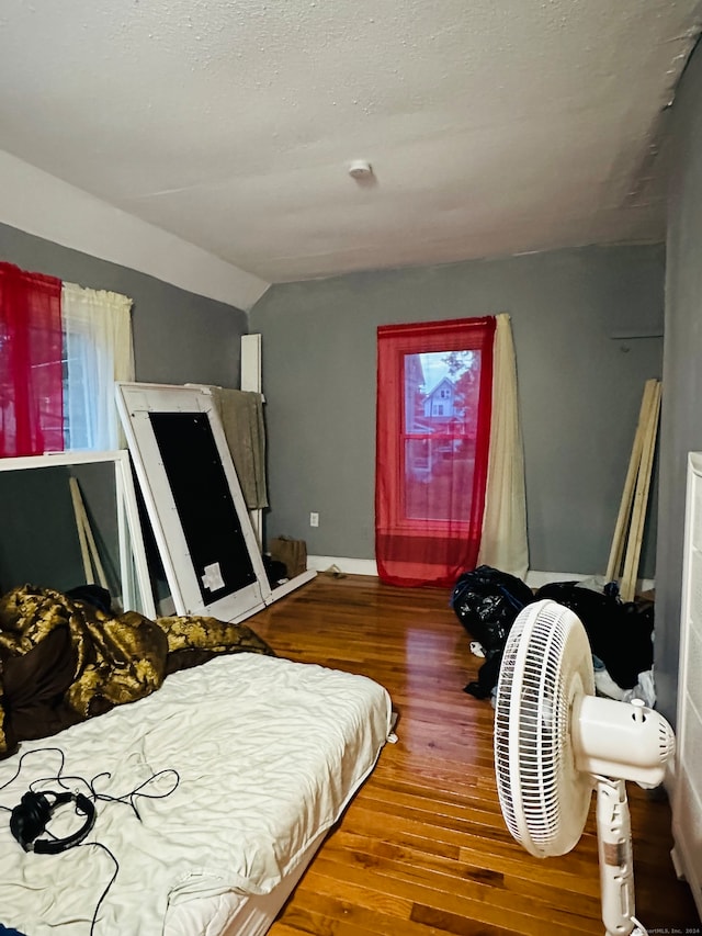 bedroom with lofted ceiling and hardwood / wood-style floors