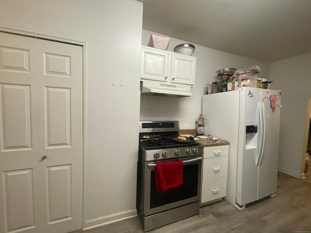 kitchen with white cabinetry, white fridge with ice dispenser, tasteful backsplash, stainless steel stove, and wood-type flooring