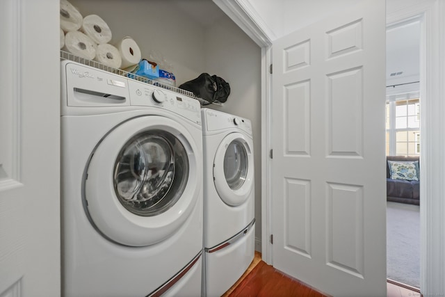 laundry area featuring separate washer and dryer and dark hardwood / wood-style floors