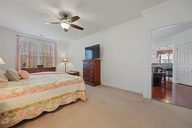 bedroom featuring ceiling fan, carpet floors, and ornamental molding