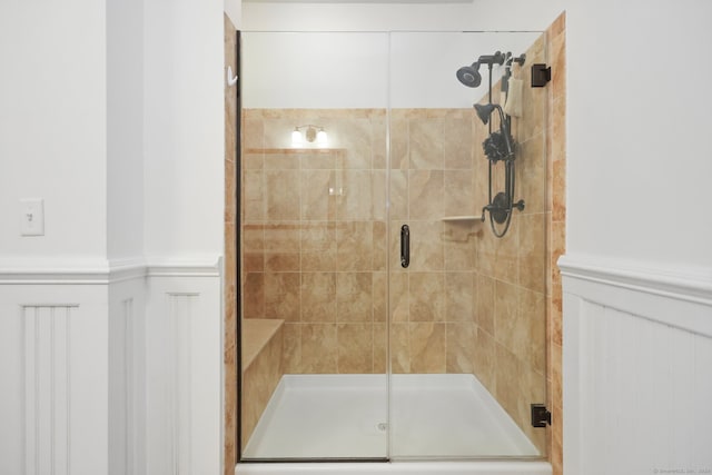 bathroom featuring a shower with door