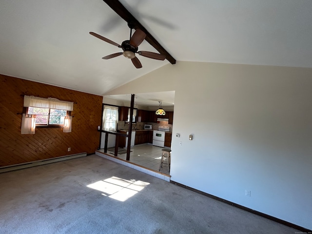 empty room featuring wood walls, a baseboard heating unit, vaulted ceiling with beams, ceiling fan, and light carpet