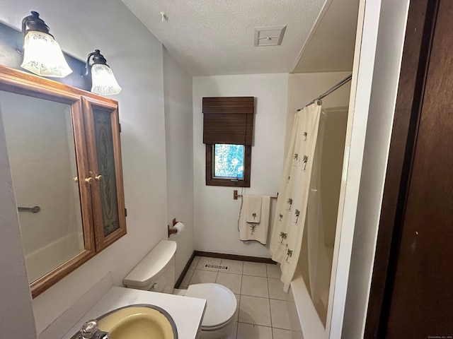 bathroom featuring a textured ceiling, walk in shower, toilet, vanity, and tile patterned flooring