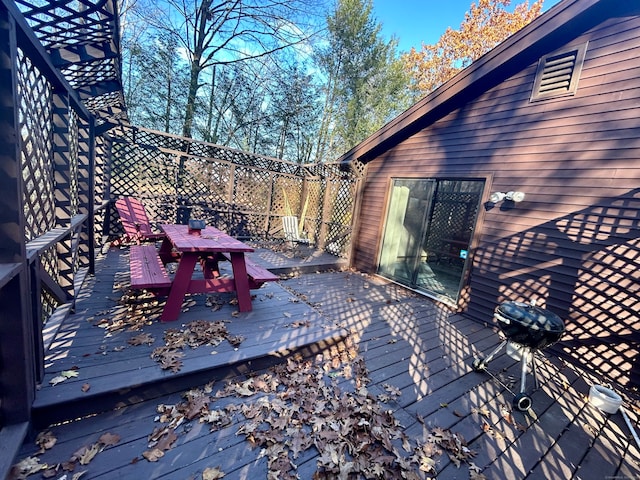 wooden deck with a grill