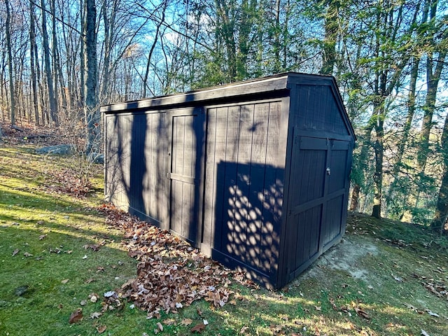 view of outdoor structure featuring a lawn