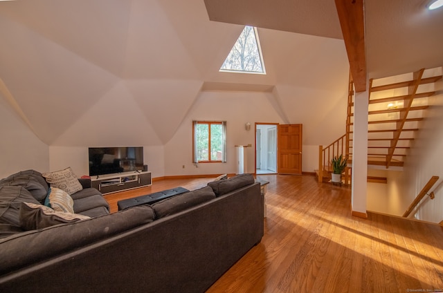 living room with wood-type flooring and vaulted ceiling