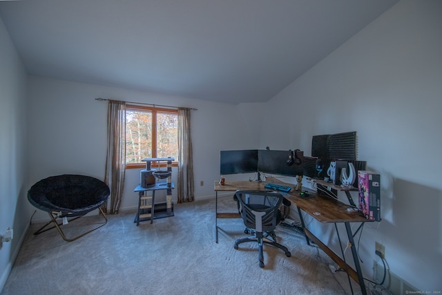 carpeted home office featuring lofted ceiling