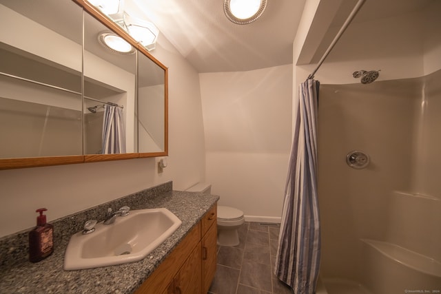 bathroom featuring toilet, vanity, tile patterned flooring, and curtained shower