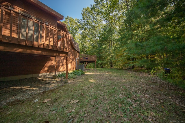 view of yard featuring a wooden deck and central AC