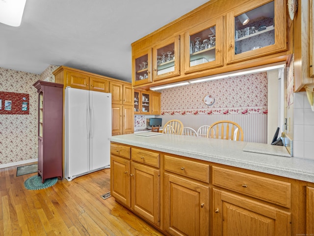 kitchen with white fridge and light wood-type flooring