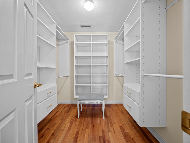 spacious closet with hardwood / wood-style floors