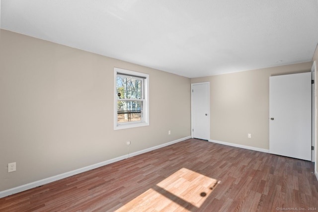 spare room with hardwood / wood-style flooring