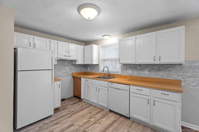 kitchen with white cabinetry, white appliances, sink, and light wood-type flooring