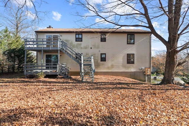 back of house featuring a wooden deck