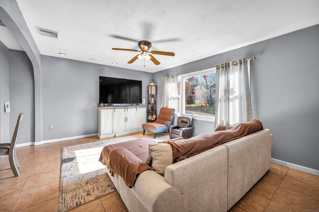 tiled living room with ceiling fan