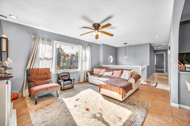 living room with ceiling fan and light tile patterned floors