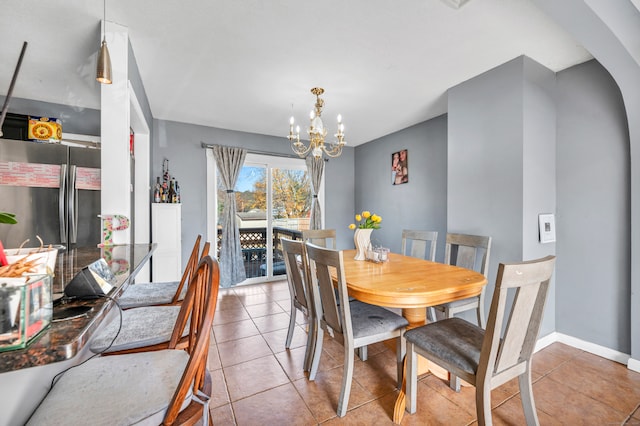 dining space featuring a chandelier and light tile patterned floors