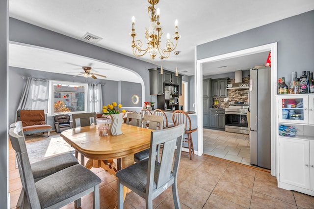 dining area featuring ceiling fan with notable chandelier and light tile patterned floors