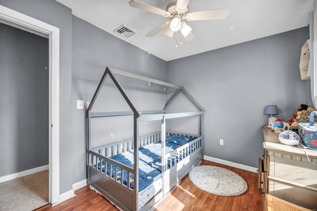 bedroom featuring hardwood / wood-style floors and ceiling fan