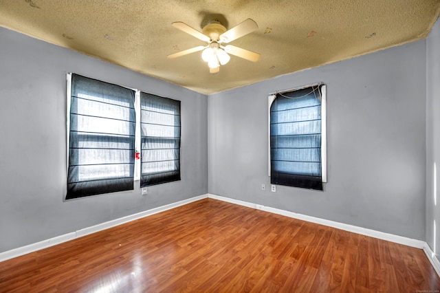 spare room featuring a textured ceiling, hardwood / wood-style flooring, and ceiling fan