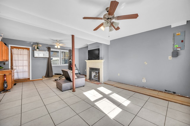 tiled living room featuring a brick fireplace, ceiling fan, and electric panel