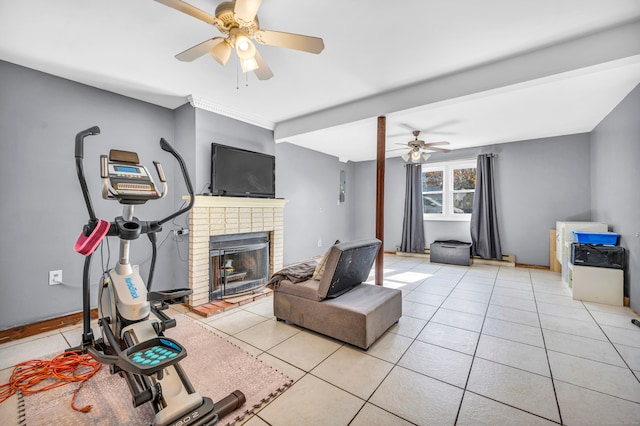 living room featuring a brick fireplace, light tile patterned flooring, and ceiling fan