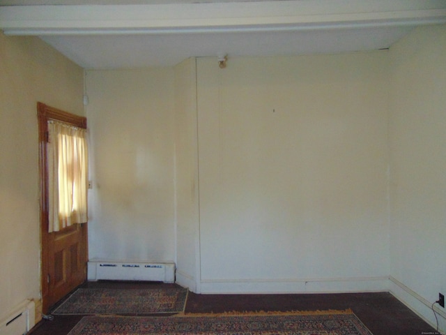 unfurnished room with a baseboard heating unit