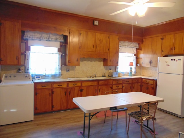 kitchen featuring washer / dryer, ceiling fan, white fridge, and light wood-type flooring