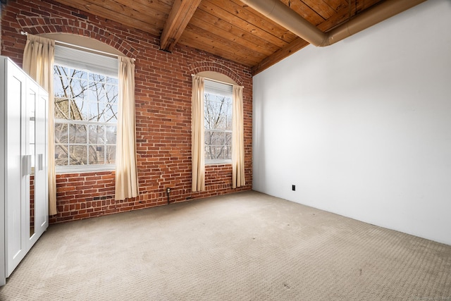 carpeted spare room with wooden ceiling, brick wall, and vaulted ceiling with beams