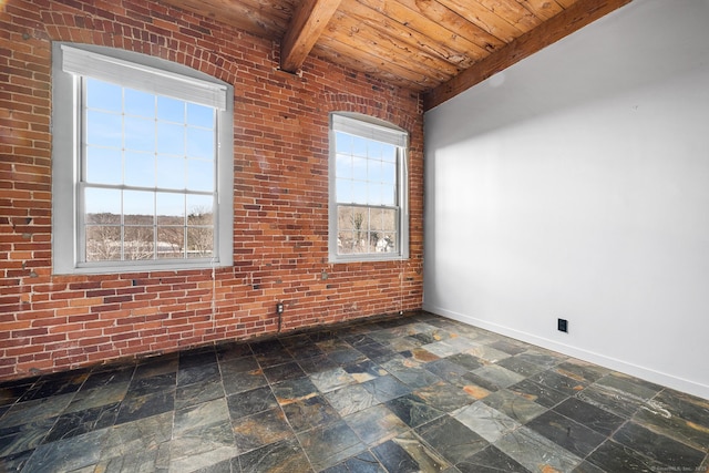 spare room with beam ceiling, plenty of natural light, brick wall, and wooden ceiling